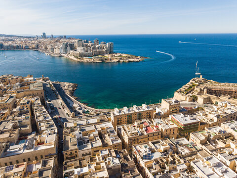 Aerial view of the iconic dome of the Basilica of Our Lady of Mount Carmel and historic limestone buildings overlooking the harbour in Valletta, Port Region, Malta.