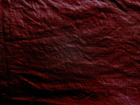 crimson red linen fabric texture background with moody shadows showing detailed macro weaving of cotton canvas material