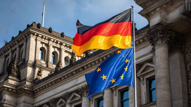 Flags of Germany and the European Union flutter in the wind near important government buildings in Berlin during a sunny day