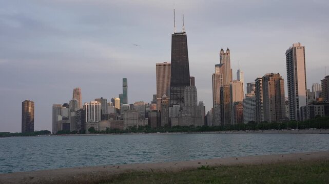 A beautiful 4K cinematic b-roll video capturing the iconic Chicago downtown skyline during the golden hour with seagulls flying across the sky. Footage showcases the majestic 875 North Michigan Ave