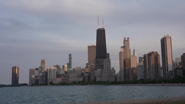 A spectacular 4K cinematic b-roll shot capturing the iconic Chicago skyline during the golden hour. The footage showcases the magnificent architecture of downtown skyscrapers, John Hancock Center