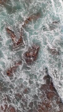 Vertical aerial drone waves on lava coastline Tenerife &mdash; portrait format