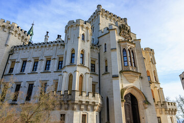 Majestic castle with gothic architecture and towering turrets under blue sky © Iurii Gagarin