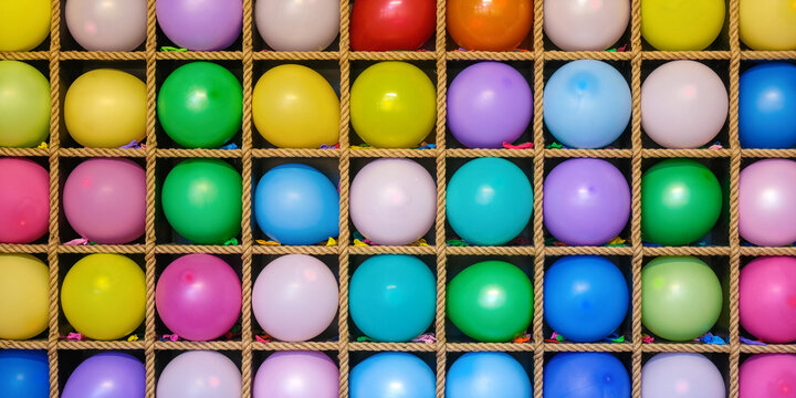 colorful banner background with intact balloons arranged in carnival game display. Children entertainment and fairground amusement concept