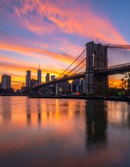 Fototapeta premium Dramatic Brooklyn Bridge Silhouette at Colorful Sunset Over Manhattan Skyline