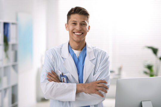 Portrait of medical assistant in white coat at clinic