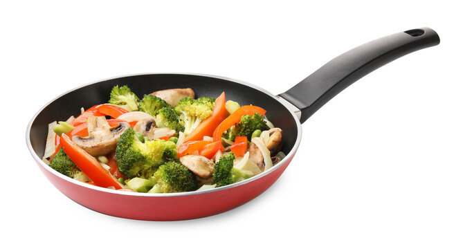 Different tasty vegetables and mushrooms in frying pan isolated on white