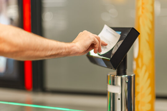 Man scanning paper receipt at self checkout terminal, using automated retail system for purchase verification and secure supermarket transaction