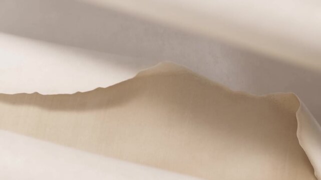 Slow pan tracking shot of torn paper sheet fragments sliding and revealing layered edges on tabletop under soft studio light