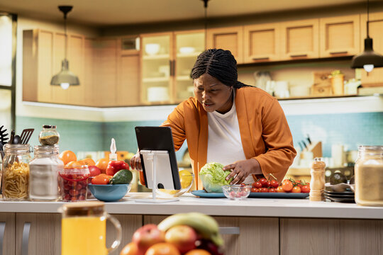African American woman, answering questions, comment section, influencer engaging with audience after filming video, Content creator recording homemade food vlog, making a recipe.
