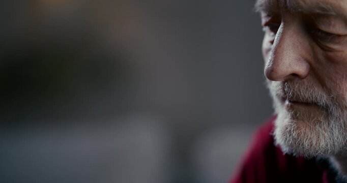 Contemplative elderly bearded man in dramatic low key portrait