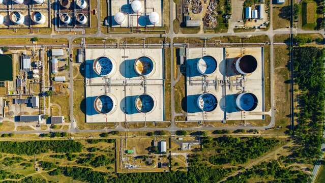Aerial view of Unipetrol RPA refinery storage tanks with circular industrial containers and a network of pipelines in Kralupy nad Vltavou 1, Stredocesky kraj, Czechia.