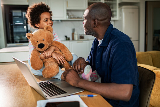 Parent and child with teddy bear at home office