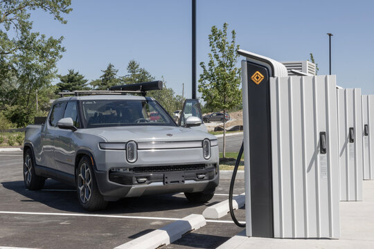 Rivian R1T pickup truck at a Rivian EV Charging station, part of the Rivian Adventure Network.