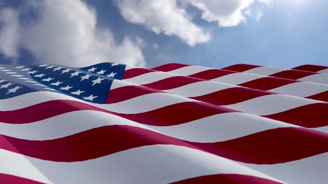Seamless Loop of American Flag Waving with Copy Space Against Blue Sky and Clouds