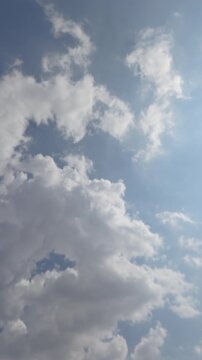 Passenger Airplane Flying Overhead Against Blue Sky and Clouds
