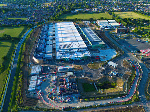 Aerial view of the Google Data Centre Waltham Cross featuring solar panels and cooling infrastructure surrounded by green fields in Cheshunt, England, United Kingdom.
