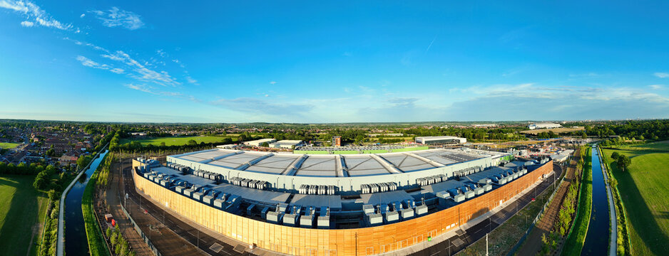 Aerial view of the Google Data Centre - Waltham Cross with its modern wooden facade and cooling systems under a clear blue sky in Cheshunt, England, United Kingdom.