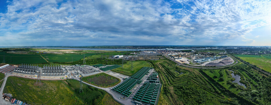 Aerial view of the Thurrock Battery Energy Storage BESS and Flexible Generation Plant with rows of green containers and electrical infrastructure in Thurrock, England, United Kingdom.