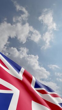 Passenger Airplane Flying Over United Kingdom Flag Waving Against Blue Sky and Clouds Background