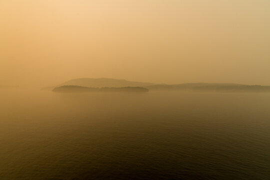 Canada, BC, Gulf Islands,  The sun and the view obscured by forest fire smoke