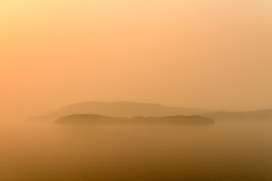 Canada, BC, Gulf Islands,  The sun and the view obscured by forest fire smoke