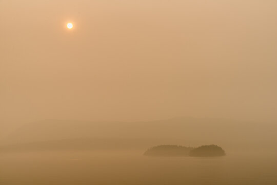 Canada, BC, Gulf Islands,  The sun and the view obscured by forest fire smoke