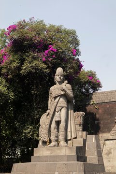 Nezahualc&oacute;yotl Fountain in Chapultepec. Historic monument that features a statue of an Aztec warrior and intricate stone reliefs in Mexico City