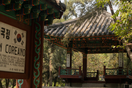 Traditional Korean pavilion structure with ornate wooden architecture and decorative details on the roof located in Chapultepec, Mexico City