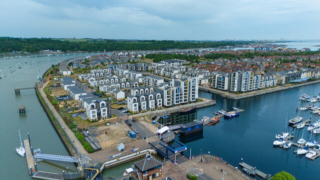 Aerial view of Saint Mary's Island residential development and marina with boats along the River Medway in Rochester, England, United Kingdom.