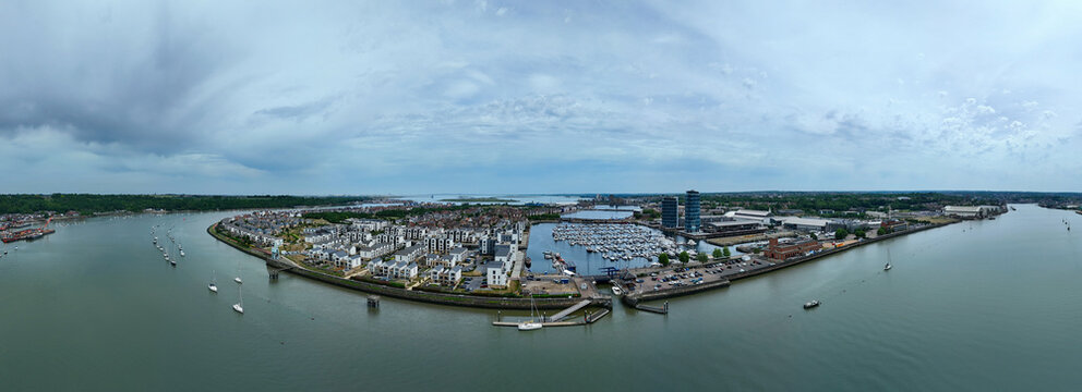 Aerial view of Saint Mary's Island featuring modern residential developments and a marina filled with yachts along the River Medway under a cloudy sky Rochester, England, United Kingdom.