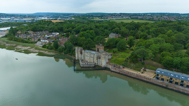 Aerial view of Upnor Castle on the banks of the River Medway surrounded by dense green woodland and residential houses in Upper Upnor, England, United Kingdom.
