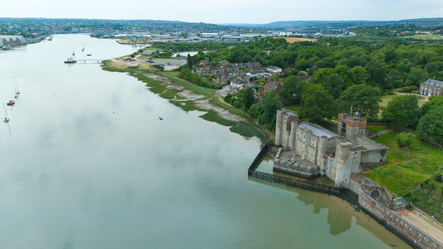 Aerial view of Upnor Castle on the banks of the River Medway with lush green trees and distant boats in Upper Upnor, England, United Kingdom.