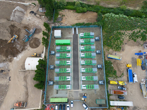 Aerial view of Damhead Creek Power Station Battery Energy Storage Systems BESS with rows of green containers in a fenced area at an industrial site Rochester, England, United Kingdom.
