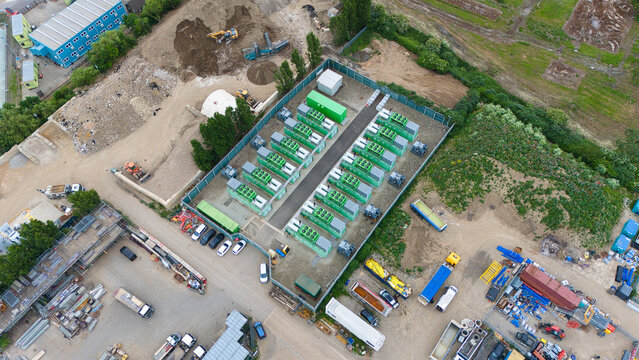 Aerial view of Damhead Creek Power Station Battery Energy Storage Systems BESS with rows of green containers and industrial equipment Rochester, England, United Kingdom.