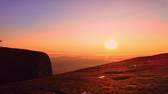 Epic sunrise at a famous Thai viewpoint, capturing tiny human figures on a colossal rock ledge above a sea of trees, evoking adventure, scale, and serenity. Panoramic Dawn at Hin Sam Wan Viewpoint