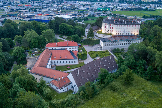 Aerial view of Schloss Ambras Renaissance castle with the city of Innsbruck and the Inn Valley behind, Tyrol, Austria