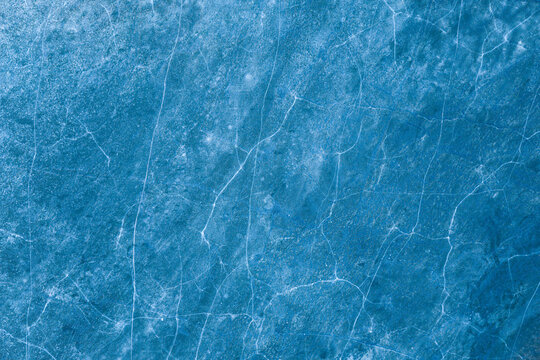 Aerial view of the frozen surface of Elk Lake featuring intricate white cracks and deep blue ice textures during winter Elk, Warmian-Masurian Voivodeship, Poland.