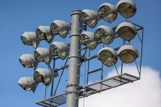 Stadium light over a baseball field with blue sky and puffy clouds in the background