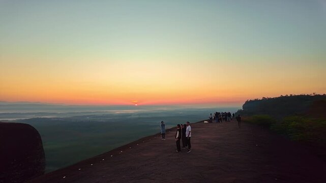 Bueng Kan, Thailand. 02 December 2025; Three Whale Rock Iconic Viewpoint of Northeastern Thailand. Epic sunrise at a famous Thai viewpoint, capturing tiny human figures on a colossal rock ledge