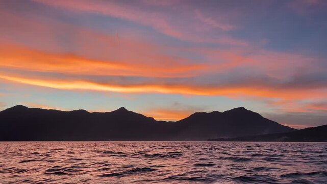 Beautiful cinematic sunset over tropical sea and mountain silhouette in Flores East Nusa Tenggara Indonesia