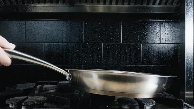 Medium frame capturing the clad wok spinning emphasizing the layered metal construction as it takes on a perfectly rounded profile under skilled craftsmanship