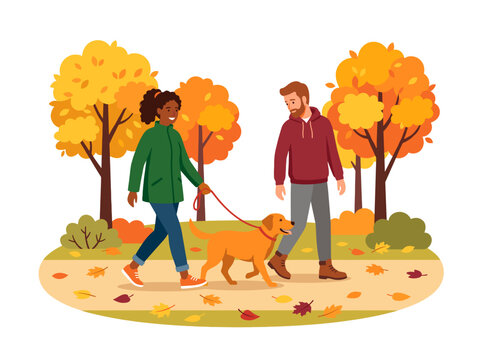 Couple walking dog in autumn park with colorful fall foliage and fallen leaves