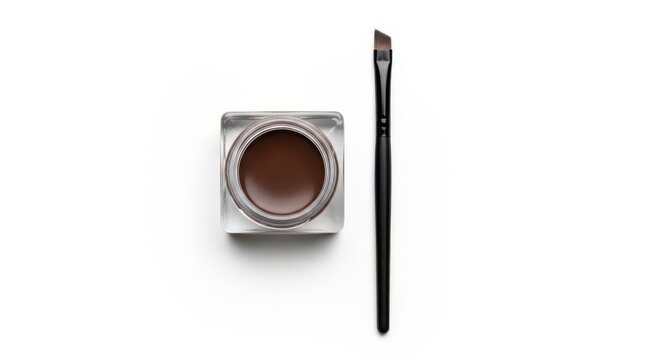 Eyebrow pomade in glass jar with angled brush isolated on white background
