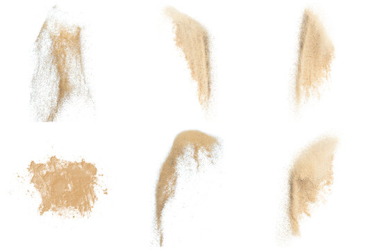 realistic photograph of natural beige sand pouring and piled elements, isolated on black for creative projects.