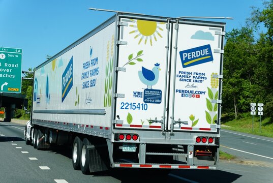 Delaware, U.S.A - May 21, 2026 - Perdue-branded semi-trailer on highway featuring colorful farm-themed graphics and company contact details.