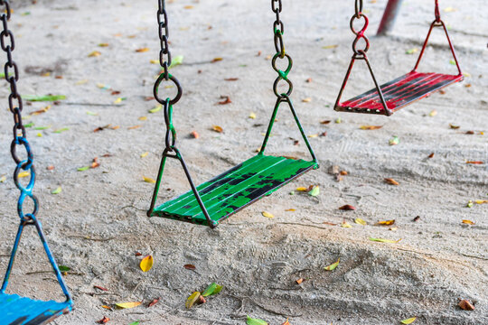 Educational Parenting. Empty Metal Chain Swing in Playground