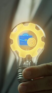 Business Model concept, a strategic plan of how business will generate revenue and reach profitability. Businessman holding lightbulb to show briefcase with dollar coin and gear icon on virtual screen