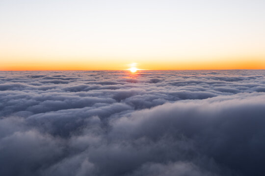 Breathtaking Sunset or Sunrise Above a Sea of Clouds with Golden Light Horizon View
