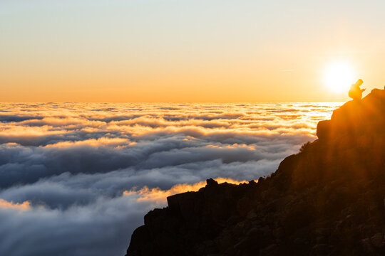 Silhouette on Mountain Peak Above Clouds, Golden Sunset Sky, Serene Landscape, Dreamy Horizon View